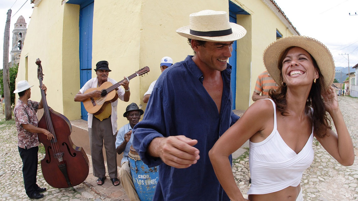 A young couple dancing on a street in Trinidad