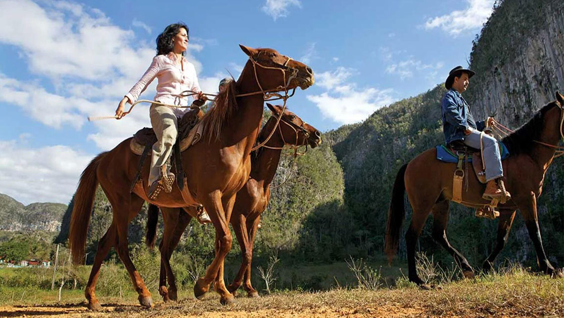 People riding horses in Viñales 
