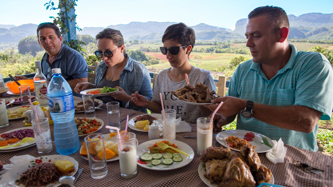 People having traditional Cuban food in an agro-ecological restaurant in Viñales 