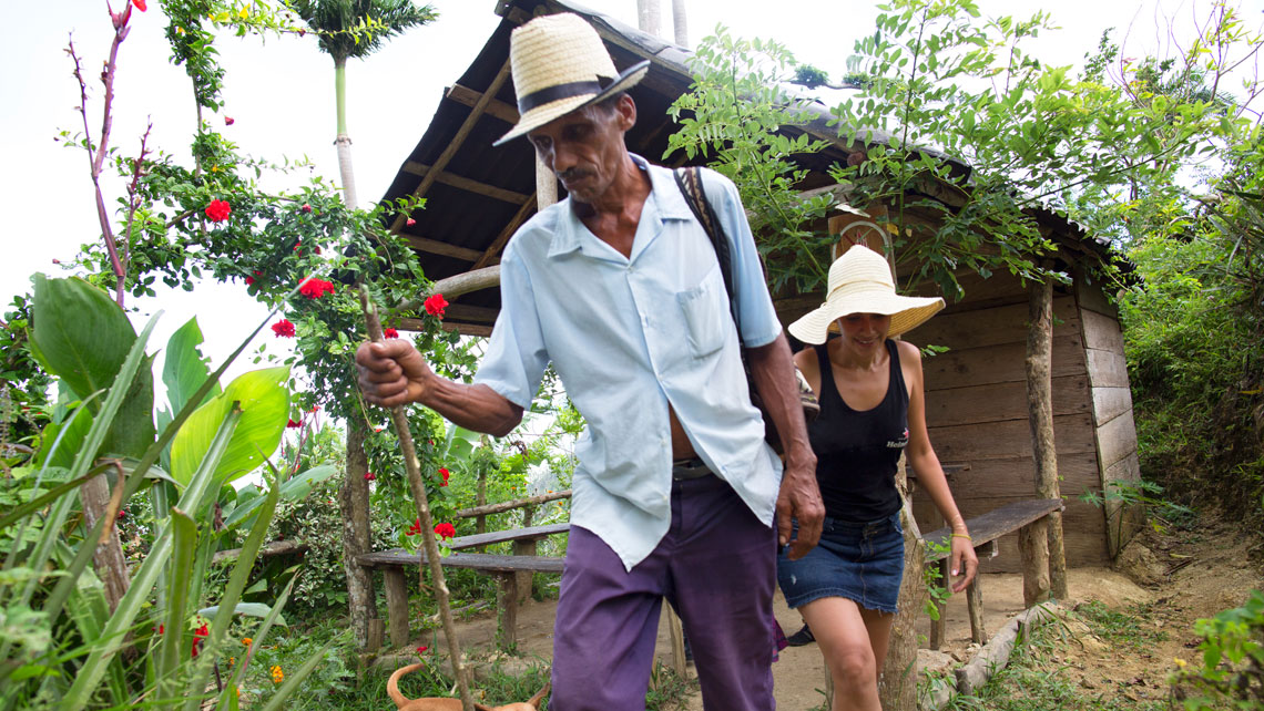 A tourist following a local in Baracoa
