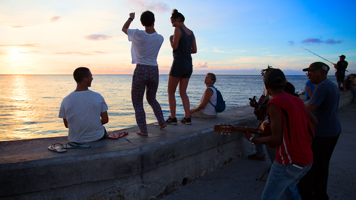 People dancing on the seawall in Havana