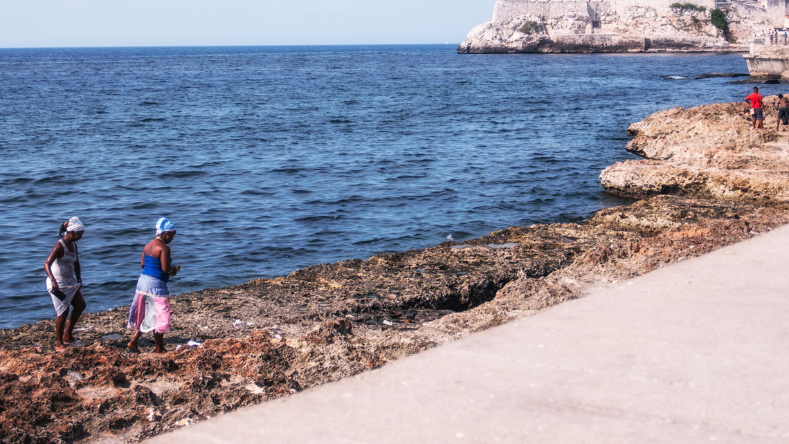 Two religious women leaving offerings to Yemaya