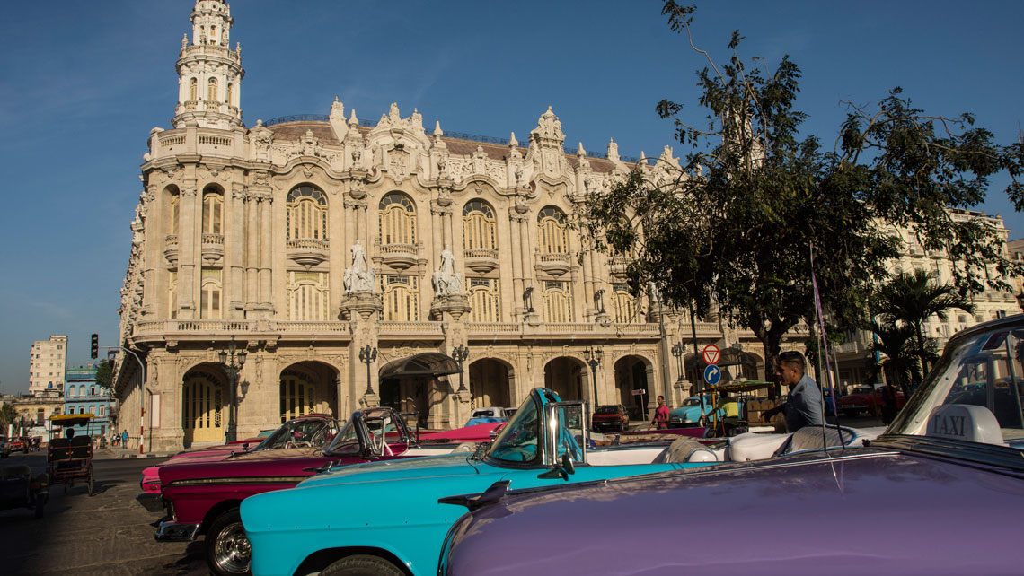 Vintage American cars parked outside Grand Theatre of Havana Alicia Alonso
