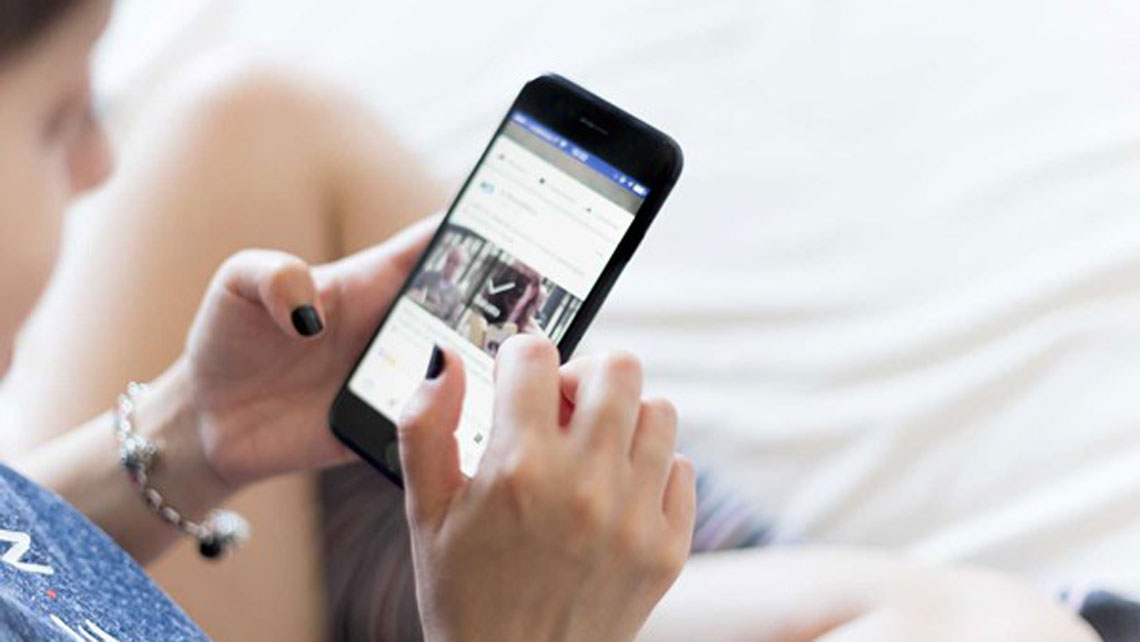 Woman using internet on her mobile phone