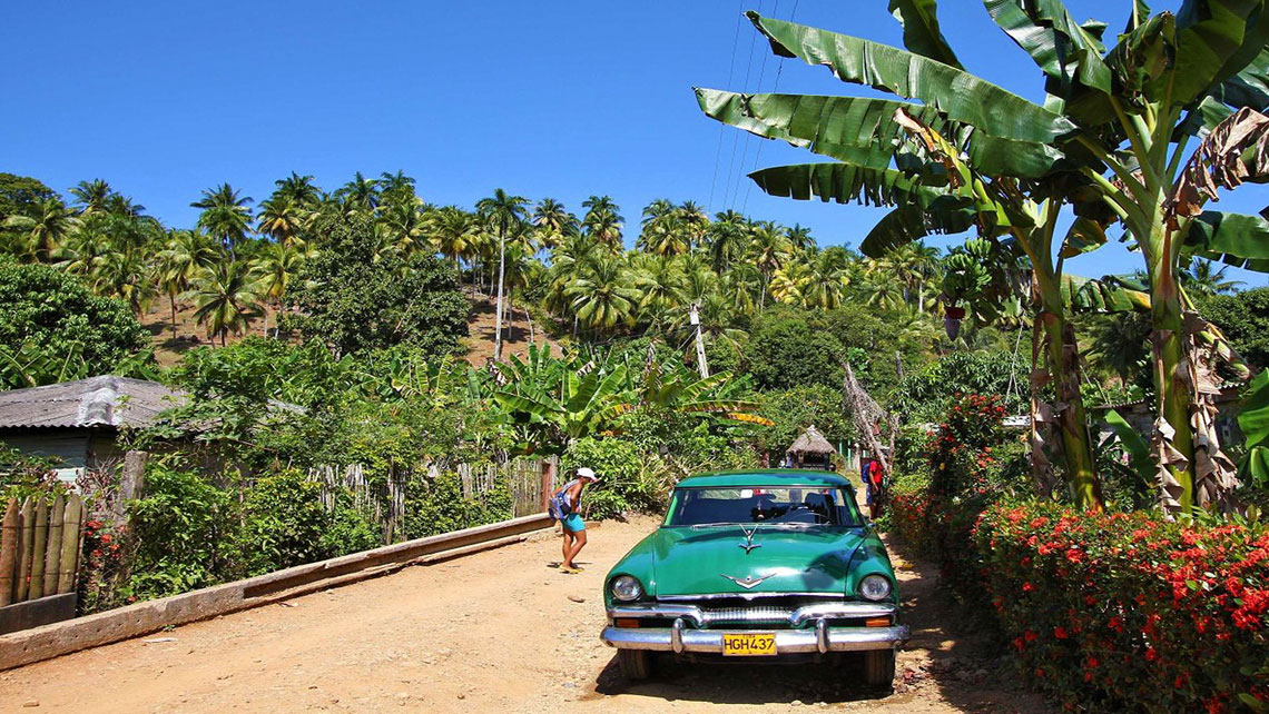 Vintage american car in a dirty road of Baracoa