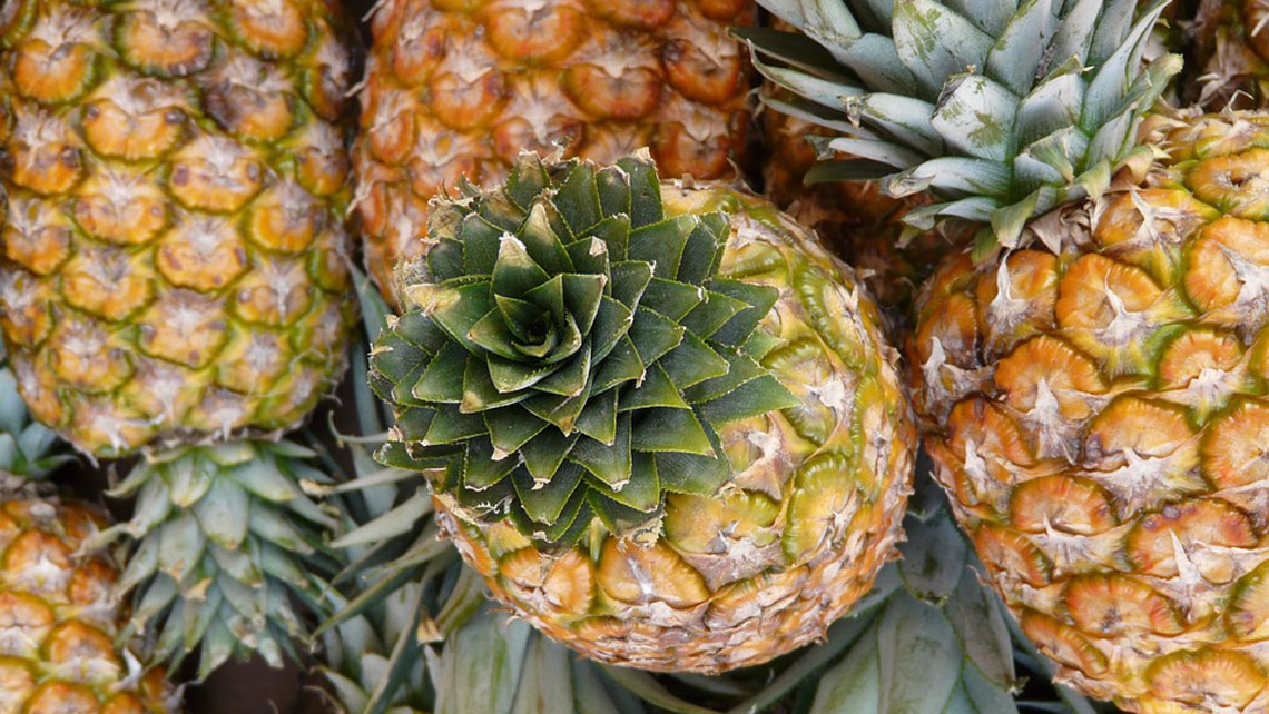 A close up of pineapples in a farmer's market in Havana