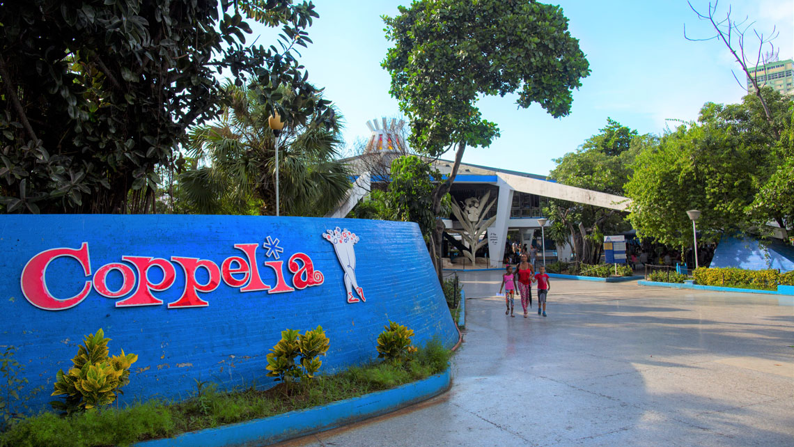 A woman and children walking in Coppelia