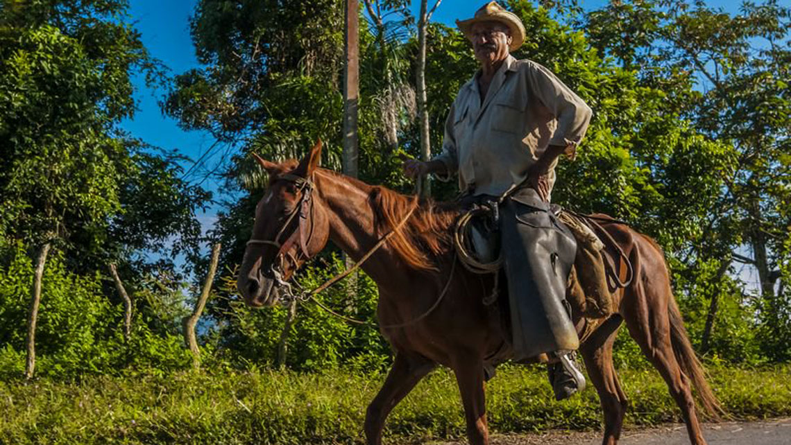 A guajiro riding a horse in Escambray Mountains