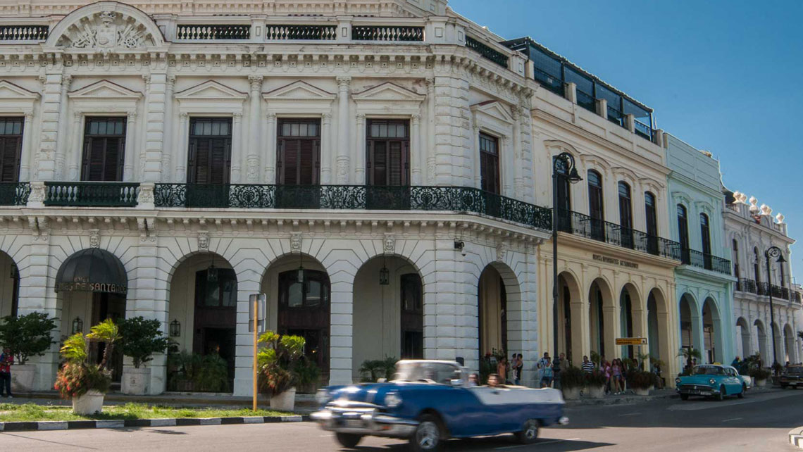 A vintage convertible american car cruising a street in Havana
