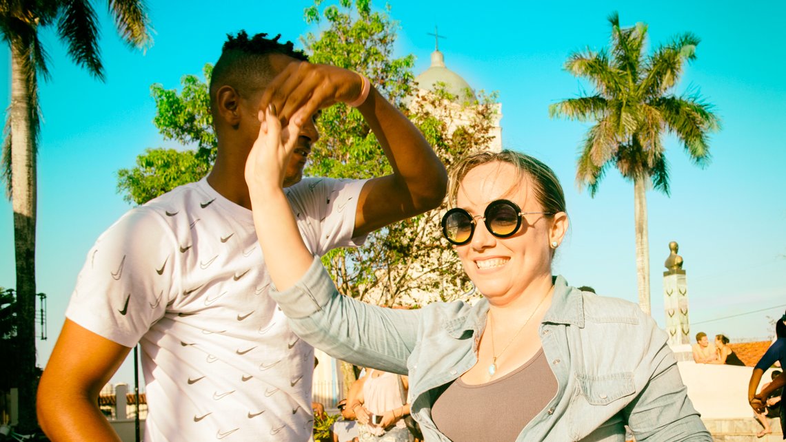 A young woman dancing salsa with a Cuban