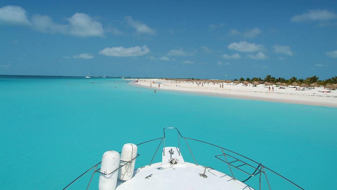 Boat in the cristal waters of Playa Santa Lucia