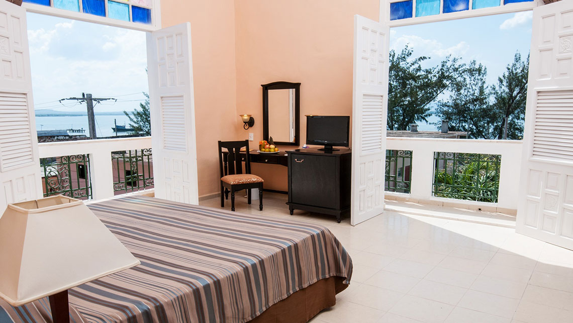 Sea views from the colourful stained-glass windows of Hotel Ordoño in Gibara