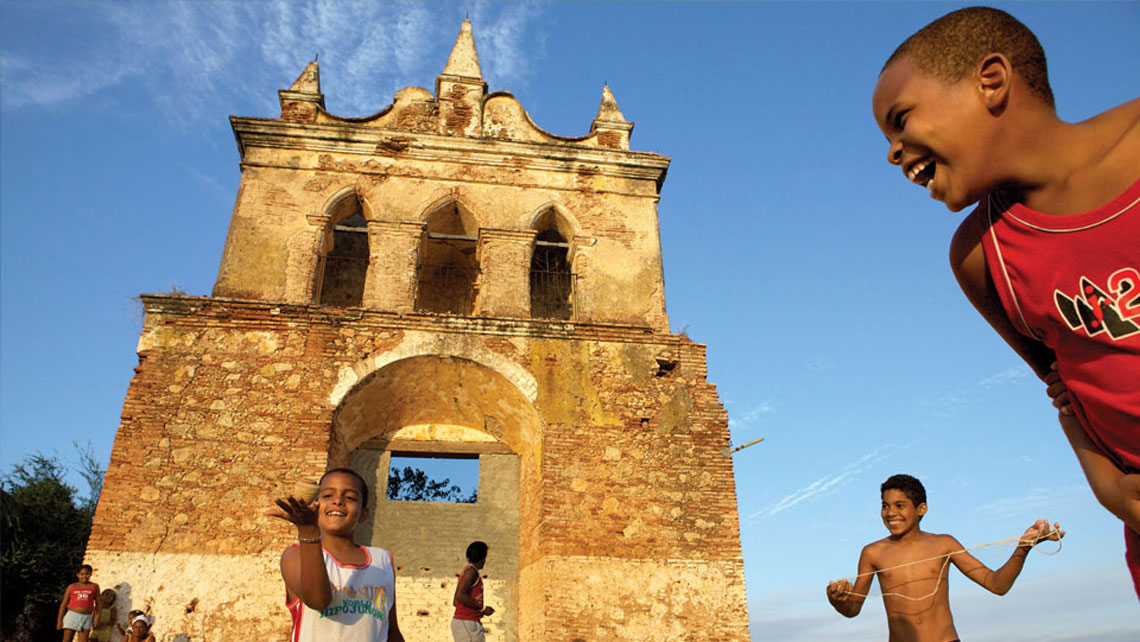 Cuban children playing near an old colonial building