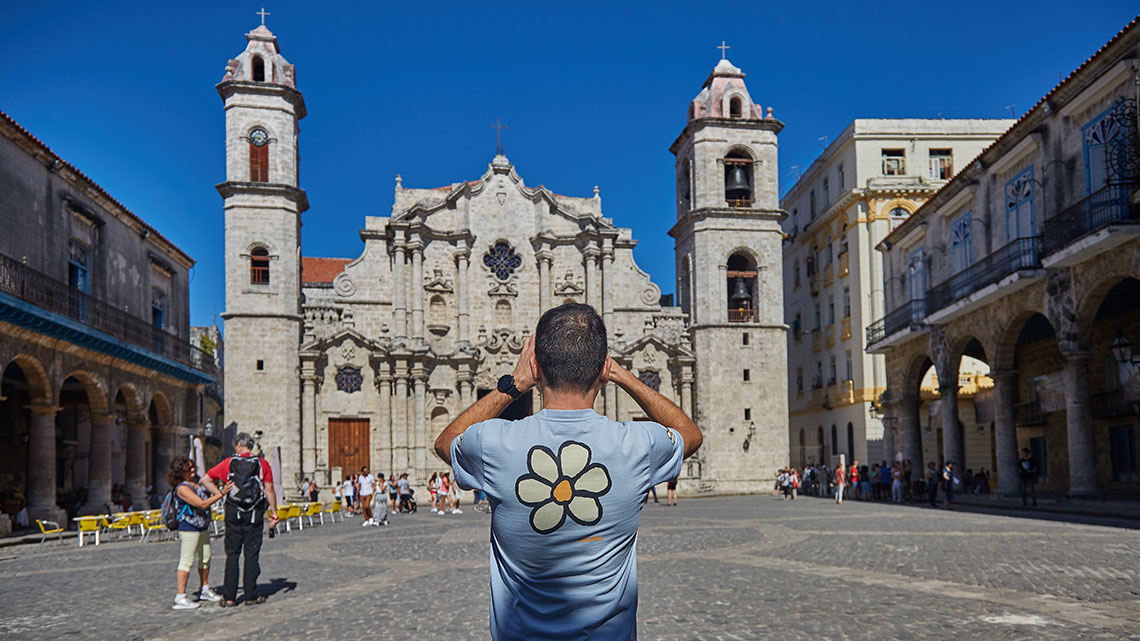 Tourist takes picture of Cathedral of Havana in Cathedral Square in Old Havana